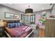 Comfortable bedroom with plaid bedding, eye-catching artwork, and a cozy sitting area at 3313 W Mullen Ave, Tampa, FL 33609