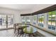 Bright breakfast nook featuring a built-in seating area, sunlit windows, and stylish flooring for casual dining and relaxation at 3313 W Mullen Ave, Tampa, FL 33609