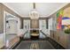 Formal dining room boasts a modern chandelier, sophisticated decor, and ample space for hosting elegant dinner parties at 3313 W Mullen Ave, Tampa, FL 33609
