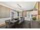 Dining room featuring a modern chandelier, sophisticated decor, and seating for eight, perfect for gatherings and formal dinners at 3313 W Mullen Ave, Tampa, FL 33609