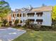 Beautiful two-story white-painted home with a columned front porch and mature landscaping at 3313 W Mullen Ave, Tampa, FL 33609