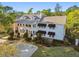 Beautiful two-story white-painted home with a columned front porch and mature landscaping at 3313 W Mullen Ave, Tampa, FL 33609