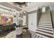 Grand foyer with elegant decor, staircase, and views into dining room, creating a welcoming entrance to the home at 3313 W Mullen Ave, Tampa, FL 33609