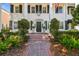 Classic white brick home with black shutters, a brick walkway, and manicured landscaping enhancing its curb appeal at 3313 W Mullen Ave, Tampa, FL 33609