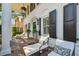 Charming front porch with brick floor and comfortable seating area, perfect for enjoying the outdoors at 3313 W Mullen Ave, Tampa, FL 33609