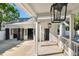 Garage with multiple doors on the exterior is adjacent to the veranda, providing access to the house and backyard at 3313 W Mullen Ave, Tampa, FL 33609