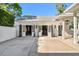 Spacious white garage with multiple access points providing ample storage and convenience for vehicle parking and projects at 3313 W Mullen Ave, Tampa, FL 33609