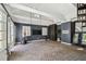 Home gym with exposed brick floors, a training dummy, and large mirrors creates a versatile space for workouts at 3313 W Mullen Ave, Tampa, FL 33609