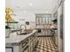 This kitchen boasts a unique floor, marble countertops, and white cabinetry with contrasting trim and modern stainless steel appliances at 3313 W Mullen Ave, Tampa, FL 33609