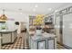 Gourmet kitchen with marble countertops, stainless steel appliances, custom cabinetry, and tiled floors at 3313 W Mullen Ave, Tampa, FL 33609