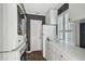 Well-organized laundry room featuring stacked washer and dryer units, accompanied by counter space, enhancing functionality at 3313 W Mullen Ave, Tampa, FL 33609