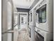Functional laundry area with stacked washer and dryer units, a full-size refrigerator, and ample storage space at 3313 W Mullen Ave, Tampa, FL 33609