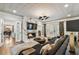 Elegant living room with a marble fireplace, modern lighting, plush seating, and large windows for abundant natural light at 3313 W Mullen Ave, Tampa, FL 33609