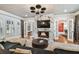 Stylish living room featuring a cozy fireplace, plush seating, ample natural light, and sophisticated decor for relaxation and comfort at 3313 W Mullen Ave, Tampa, FL 33609