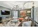 Modern living room boasts a comfortable sofa, stylish lighting, and a large television, perfect for relaxation and entertainment at 3313 W Mullen Ave, Tampa, FL 33609