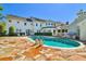 Backyard features a pool, stone patio, outdoor grill area and expansive lawn in this amazing home at 3313 W Mullen Ave, Tampa, FL 33609
