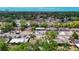 Aerial neighborhood view showcasing the home's location among mature trees with the city skyline in the distance at 3407 N 48Th St, Tampa, FL 33605