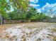 Spacious backyard featuring a privacy fence, mature trees, and potential for outdoor living and recreation at 3407 N 48Th St, Tampa, FL 33605