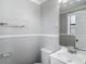 Bathroom featuring a large mirror, vanity, toilet, and towel rack at 3407 N 48Th St, Tampa, FL 33605