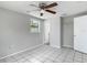 Bedroom features tile flooring, a window, ceiling fan, closet, and interior door at 3407 N 48Th St, Tampa, FL 33605