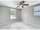 Bedroom features tile flooring, two windows, and a ceiling fan at 3407 N 48Th St, Tampa, FL 33605