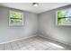 Bedroom featuring tile floors and two large, bright windows at 3407 N 48Th St, Tampa, FL 33605