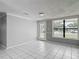 Bright living room with tile floors, large window and access to the backyard at 3407 N 48Th St, Tampa, FL 33605