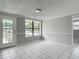 Bright living room with tile floors, large window and access to the backyard at 3407 N 48Th St, Tampa, FL 33605