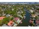 An aerial view of waterfront homes with docks on a canal surrounded by trees in a residential community at 511 Erie Ave, Tampa, FL 33606