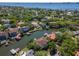Aerial view of homes with private boat docks on a canal surrounded by lush green trees on a sunny day at 511 Erie Ave, Tampa, FL 33606