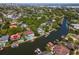 An aerial view of waterfront homes with private docks on a canal surrounded by lush trees on a sunny day at 511 Erie Ave, Tampa, FL 33606