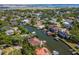 An aerial view of waterfront homes with private docks on a canal surrounded by lush trees in a neighborhood at 511 Erie Ave, Tampa, FL 33606