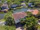 A high angle view of a home with waterfront access, tile roof, beautiful landscaping and brick driveway at 511 Erie Ave, Tampa, FL 33606