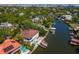 A high angle view of a home on a waterfront, with lush green landscaping and a boat dock at 511 Erie Ave, Tampa, FL 33606
