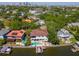Stunning aerial view of waterfront home with pool, boat dock, and lush landscaping in a desirable neighborhood at 511 Erie Ave, Tampa, FL 33606