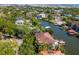 Aerial view of canal front homes with private boat docks surrounded by lush green trees in a community at 511 Erie Ave, Tampa, FL 33606