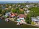 A panoramic aerial view of a waterside home with a pool, boat dock and skyline in the distance at 511 Erie Ave, Tampa, FL 33606