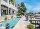 Inviting waterfront backyard with pool, spa, covered patio, and boat dock, perfect for outdoor living at 511 Erie Ave, Tampa, FL 33606
