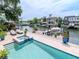 An outdoor pool and boat dock is shown with patio furniture, providing a relaxing space at 511 Erie Ave, Tampa, FL 33606