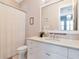 Charming bathroom features a white vanity with a modern sink and a decorative framed mirror at 511 Erie Ave, Tampa, FL 33606