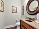 Powder room with wood vanity, granite countertop, and dark wood floors at 511 Erie Ave, Tampa, FL 33606