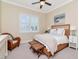 Bedroom with wicker furniture, including bed, side tables, chair, and woven stools at 511 Erie Ave, Tampa, FL 33606