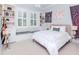 Bright bedroom features built-in shelving, window seats, and a cozy, comfortable bed at 511 Erie Ave, Tampa, FL 33606
