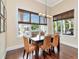 Bright dining room with wood floors, waterfront views, modern light fixture, and large windows at 511 Erie Ave, Tampa, FL 33606