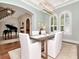 Dining room view showcasing arched windows, modern chandelier, and entrance to the foyer at 511 Erie Ave, Tampa, FL 33606