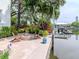 Waterfront property featuring a fire pit and a private dock, ideal for relaxation and entertainment at 511 Erie Ave, Tampa, FL 33606