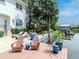 Exterior view of a waterfront home featuring a private dock and a relaxing lounge area at 511 Erie Ave, Tampa, FL 33606