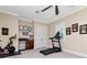 This exercise room features a ceiling fan, neutral walls, a treadmill, and a stationary bike at 511 Erie Ave, Tampa, FL 33606