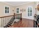 Open hallway with wood floors, windows with shutters, and elegant staircase at 511 Erie Ave, Tampa, FL 33606