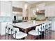 Bright kitchen with a large island, white cabinets, stainless steel appliances, and stylish pendant lighting at 511 Erie Ave, Tampa, FL 33606